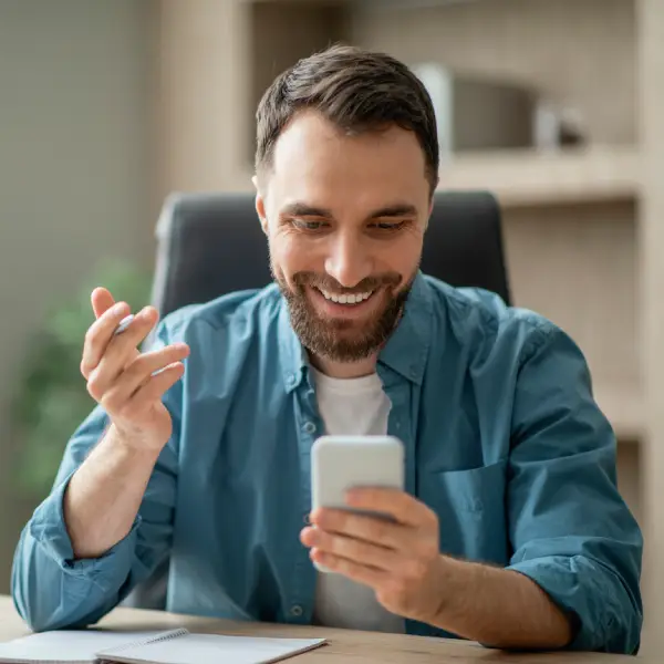 Business owner smiling at positive social stats shown by a Webwise strategist