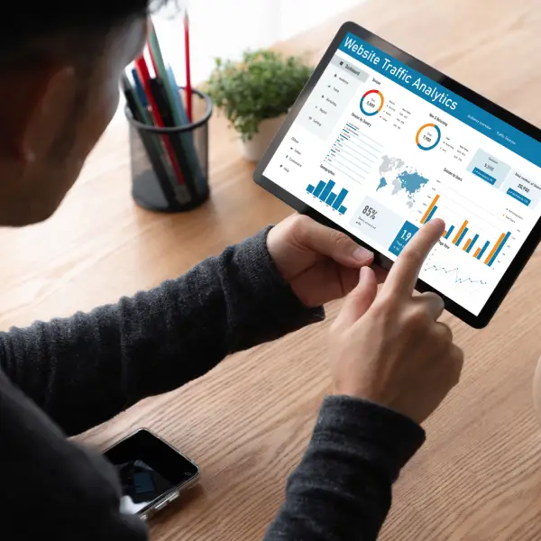 Happy business owner checking increased eCommerce metrics with Webwise expert