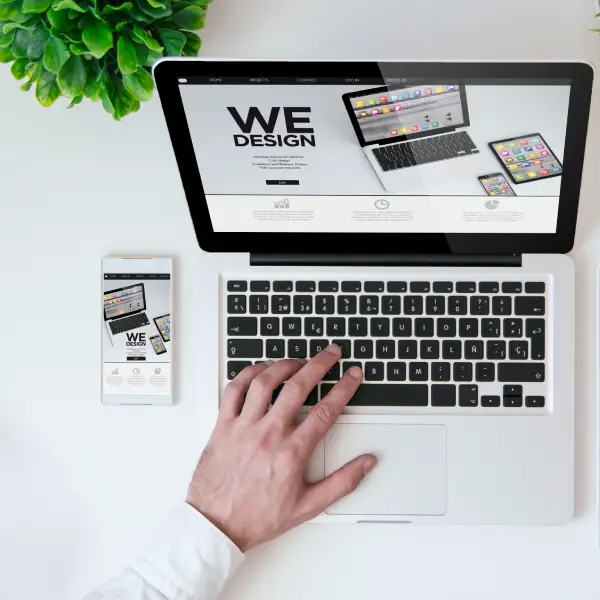 Clean, modern business website shown on both laptop and smartphone